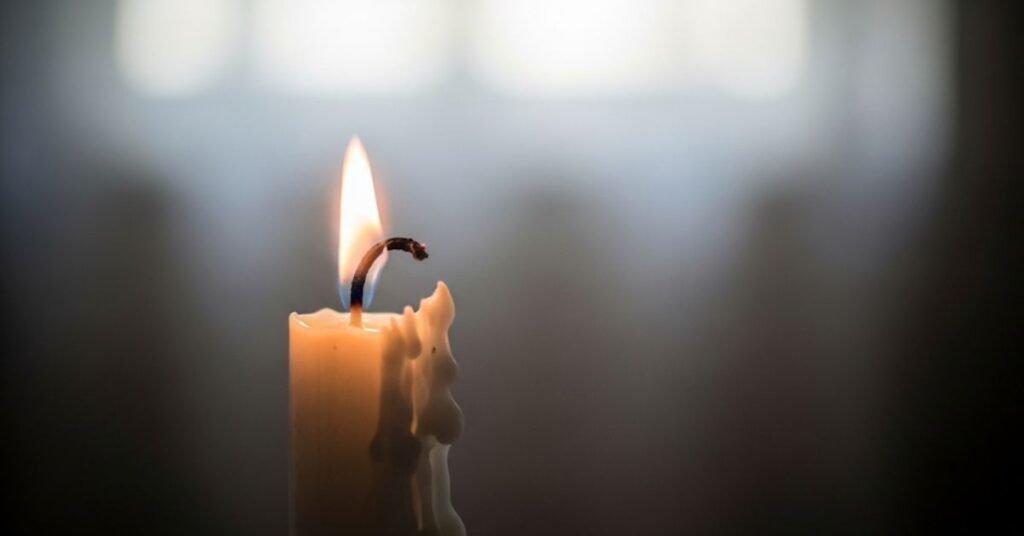 Unburned Yahrzeit candle left on a table after forgetting to light it. bathandbodyworkscandles.store